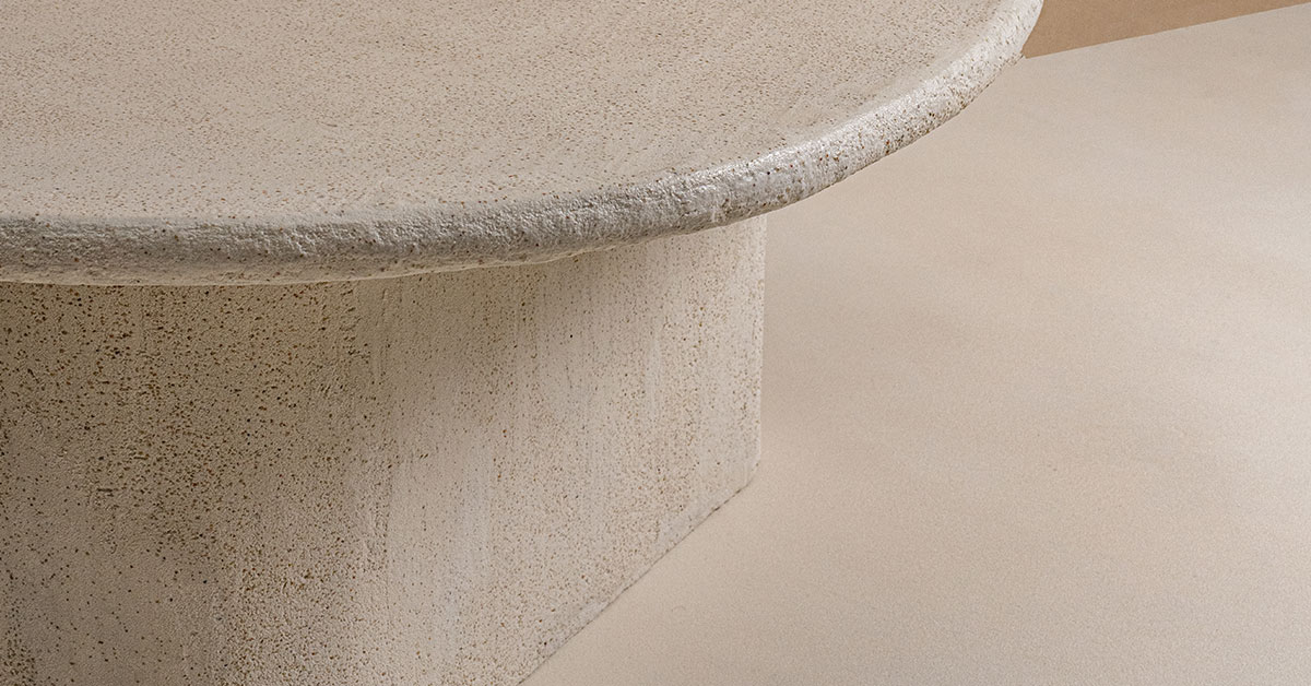 Microtopping flooring installation showing seamless concrete overlay with smooth texture on curved architectural feature