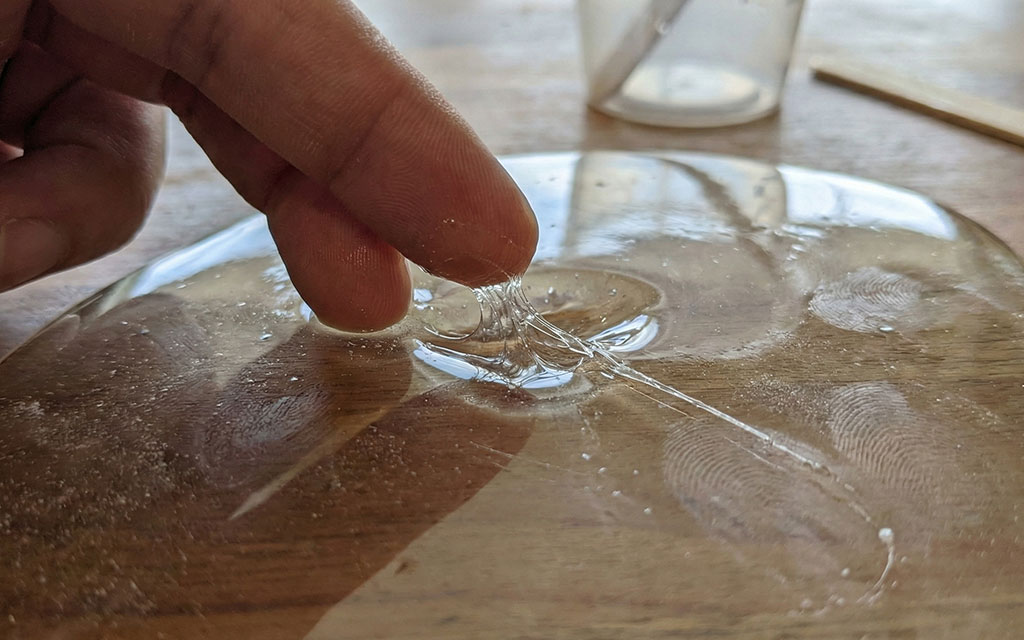 Testing tacky sticky epoxy resin showing incomplete curing and soft spots on surface
